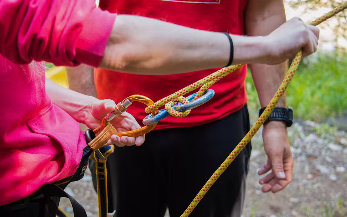 Close-up of canyoning safety rope and carabiner setup during Polylimnio Waterfalls zipline adventure in Greece
