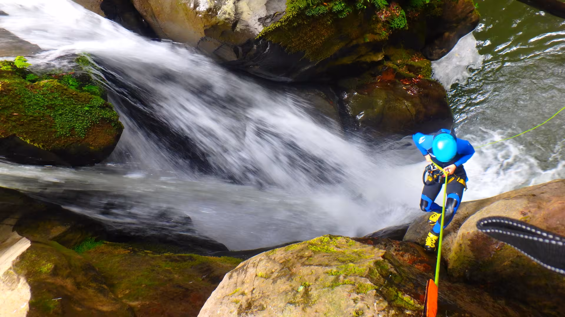 Canyoning at Salto do Cabrito, Azores: adventurer rappels beside waterfall on full-day tour with transport