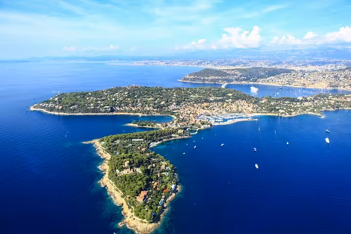 Aerial view of Cap Ferrat peninsula and Saint-Jean-Cap-Ferrat village surrounded by blue Mediterranean Sea near Nice