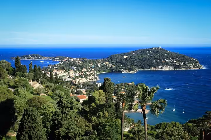 Aerial view of Cap Ferrat peninsula and Beaulieu-sur-Mer bay with blue Mediterranean Sea from Nice