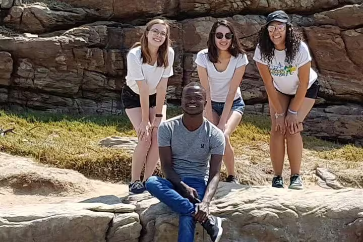 Group of tourists enjoying the rocky landscape at the Cape of Good Hope during a full-day tour from Cape Town.