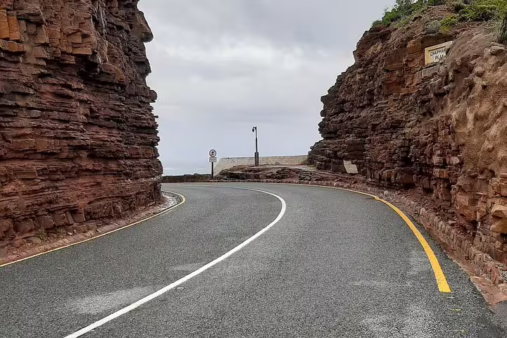 Scenic drive through rocky cliffs on the way to Cape of Good Hope, highlighting natural beauty and adventure.