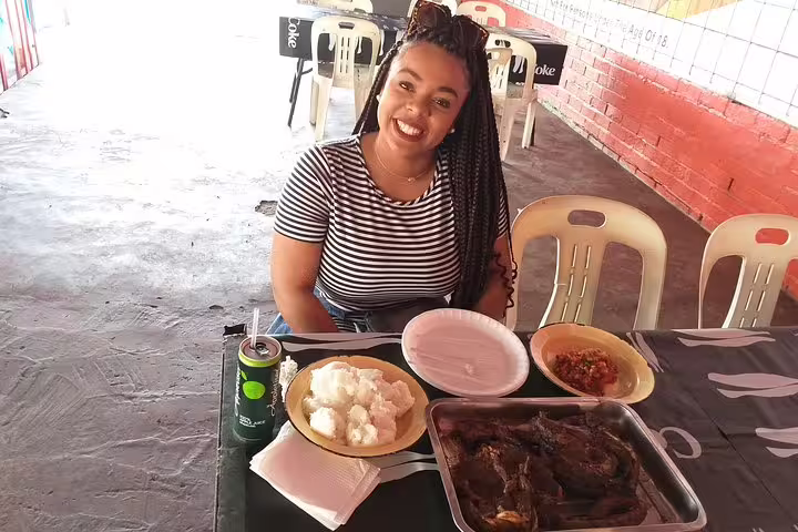 Smiling participant enjoying a local meal during the Langa Township cooking class, highlighting authentic South African cuisine.