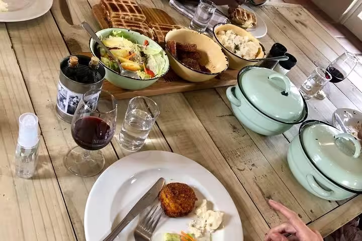 A diverse spread of traditional dishes and drinks at a Bokaap cooking class, showcasing South African culinary heritage.
