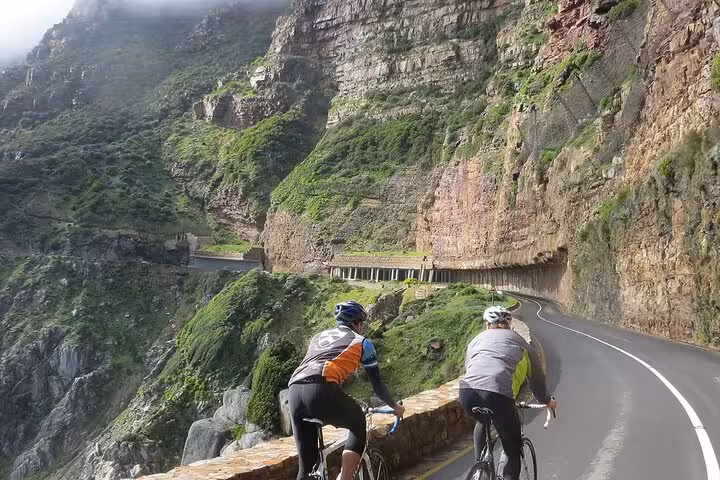 Cyclists enjoying a scenic ride along the cliffs of Cape of Good Hope with stunning ocean views.