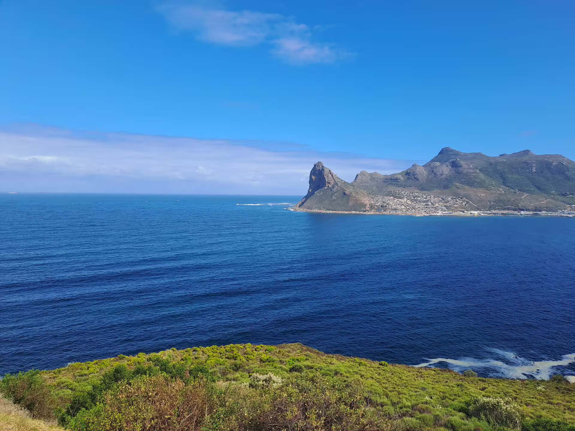 Scenic view of Cape Point's rugged coastline and blue ocean under a clear sky, offering a breathtaking landscape in South Africa.