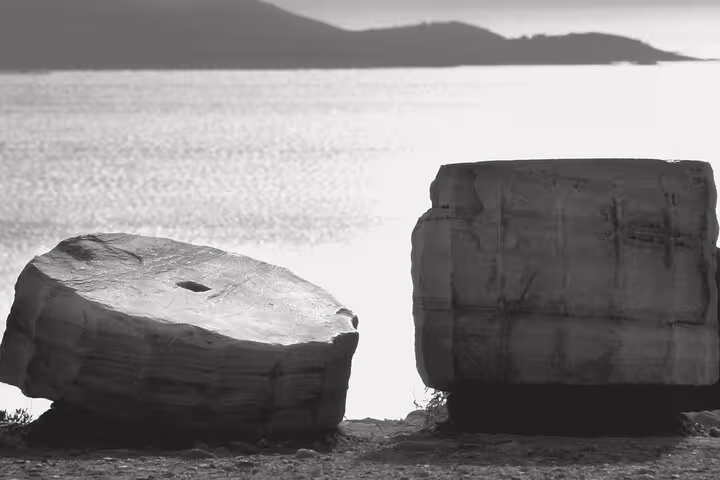 Ancient marble blocks near Cape Sounion overlooking the Aegean on a Temple of Poseidon tour from Athens