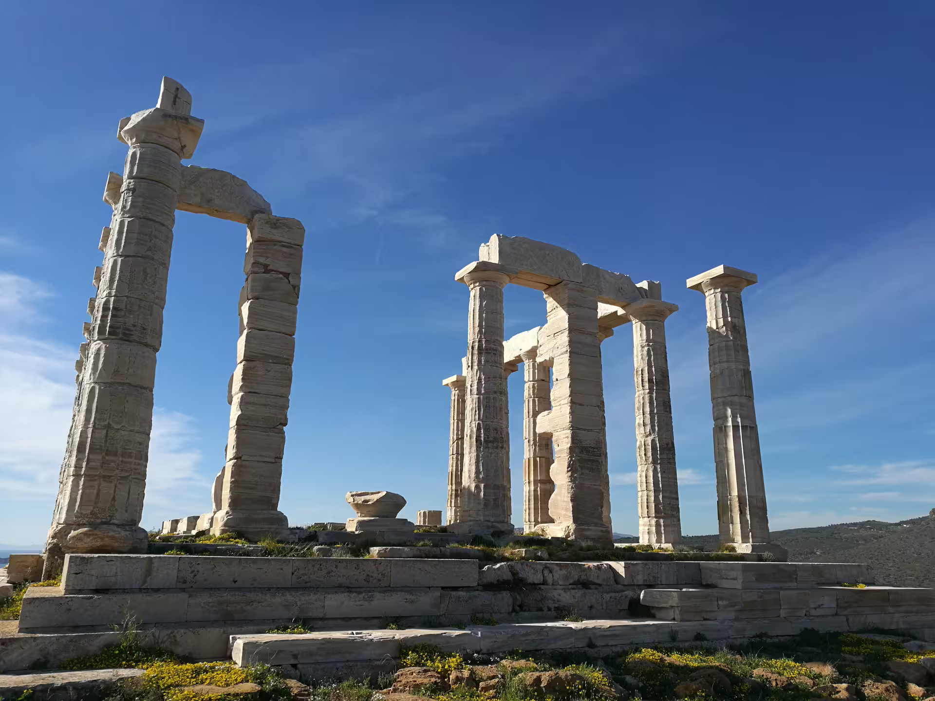 Cape Sounion Temple of Poseidon ruins under blue sky, highlight stop on private Athens Riviera sunset tour