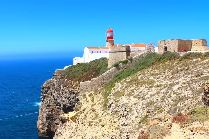 Cape St. Vincent's iconic lighthouse perched on dramatic cliffs overlooking the Atlantic Ocean in Algarve, Portugal.