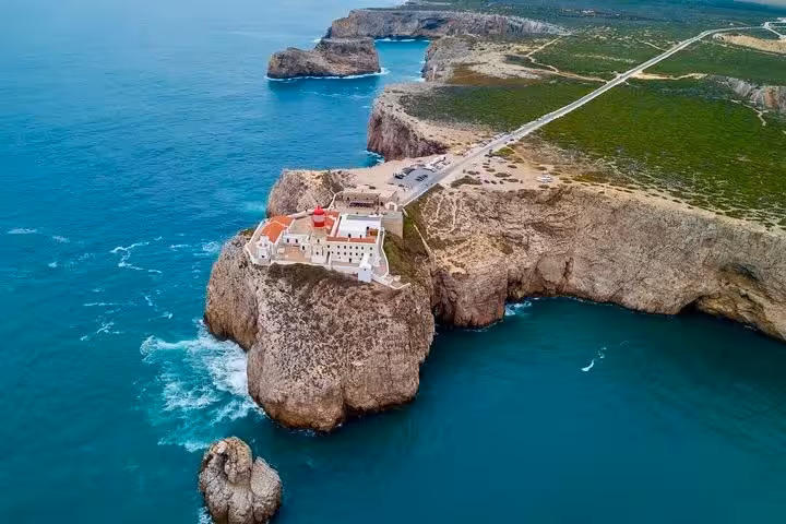 Aerial view of Cape St Vincent lighthouse on dramatic cliffs in Sagres during a coastal adventure from Lagos Algarve