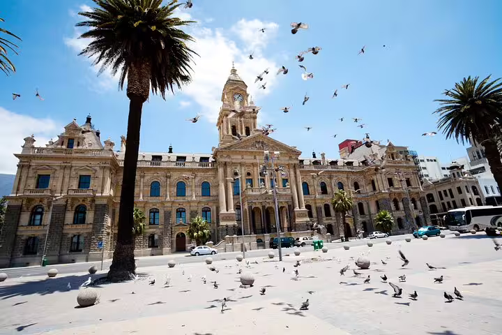 Historic Cape Town City Hall with palm trees and pigeons, a highlight of the Cape Town City and Table Mountain tour.