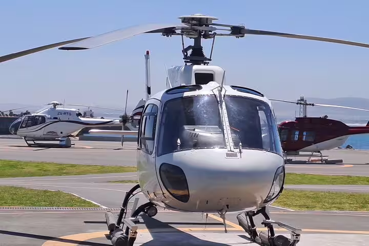Helicopter ready for scenic tour from Cape Town to Hout Bay, showcasing Atlantic Coast adventures.