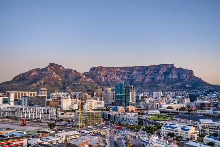 Cape Town skyline at sunset with Table Mountain views, a highlight of full day Cape Town city sightseeing tour