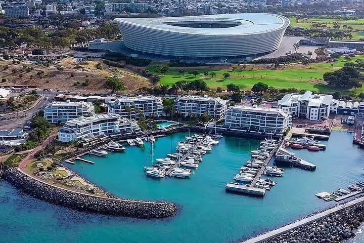 Aerial view of Cape Town Stadium and V&A Waterfront marina, a key highlight of a private historical walking tour.