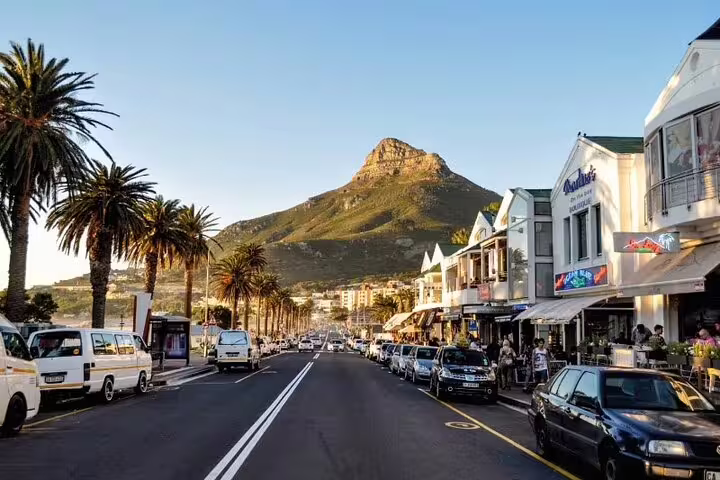Scenic view of Cape Town's bustling street with Lion's Head Mountain in the background.