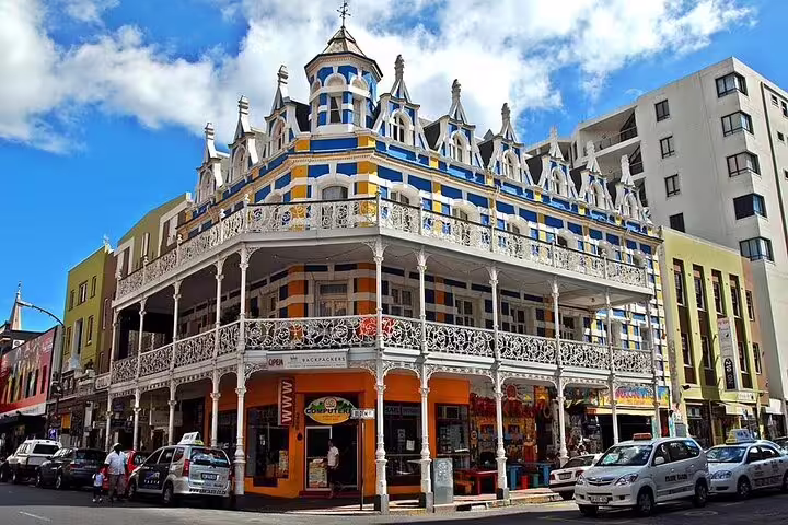 Colorful Victorian-style building in Cape Town's bustling city center, showcasing rich architectural history.
