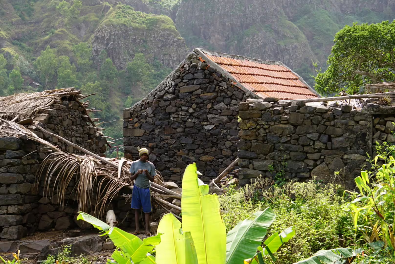 Local man in front of traditional stone houses in Principal Valley, showcasing rural life on a Cape Verde hiking tour.