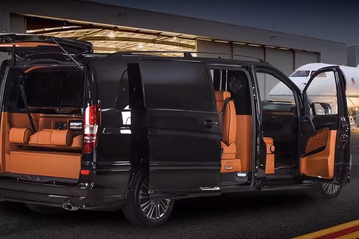 Luxury black van with tan leather seats for Cappadocia airport private transfer, door open for pickup