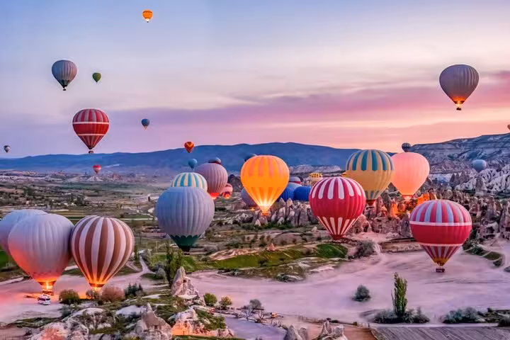 Cappadocia sunrise hot air balloons over valleys, a scenic backdrop often paired with camel ride tours in Turkey