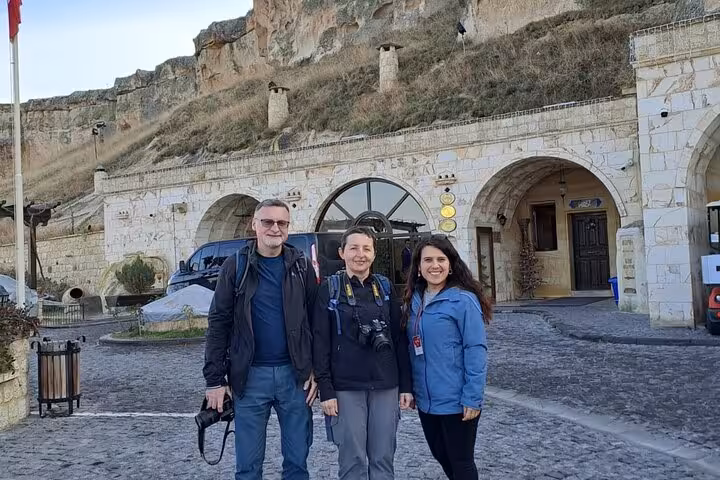 Travelers meet guide at Cappadocia cave hotel entrance for a full-day sightseeing tour with private car