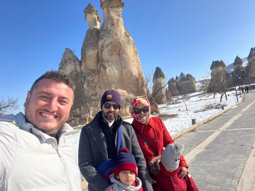 Family photo by Cappadocia fairy chimneys in winter, highlight of 7-day Istanbul Cappadocia Ephesus tour by flights