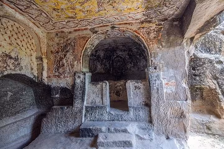 Frescoed rock-cut chapel interior in Cappadocia, hidden heritage site visited on full-day private tour