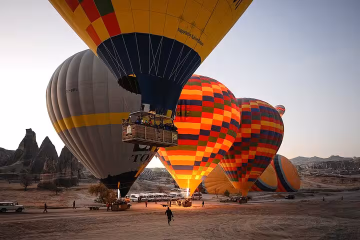 Close-up Cappadocia hot air balloon basket at sunrise with colorful balloons during Balloon Tour Cappadocia