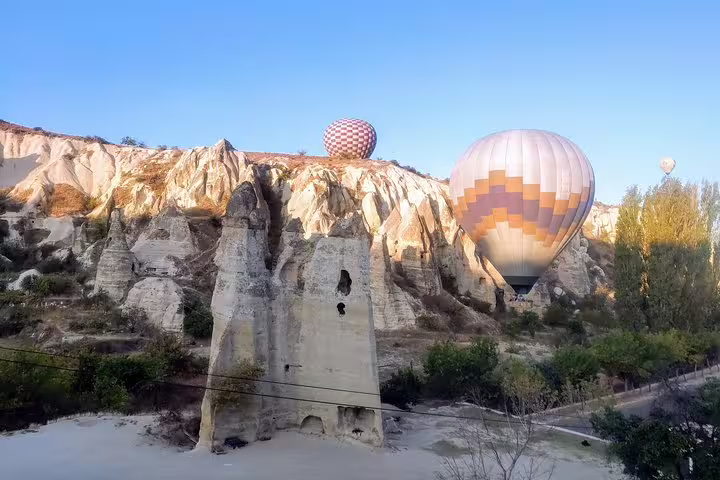 Cappadocia hot air balloons over fairy chimneys at sunrise, must-see on 10-day private Turkey tour itinerary
