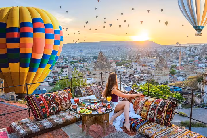 Rooftop breakfast with Cappadocia hot air balloons at sunrise on 2-day Cappadocia Highlights Tour from Istanbul