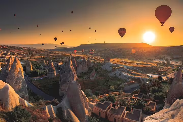 Sunrise hot air balloons over Cappadocia fairy chimneys on 2 day 1 night tour from Istanbul