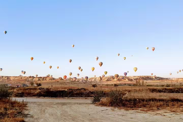 Cappadocia sunrise hot air balloons over fairy chimneys on 8-day mini group Turkey tour from Istanbul