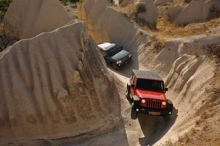 Cappadocia Jeep Safari Tour driving through narrow rock canyon trails, 4x4 off-road ride in fairy chimneys