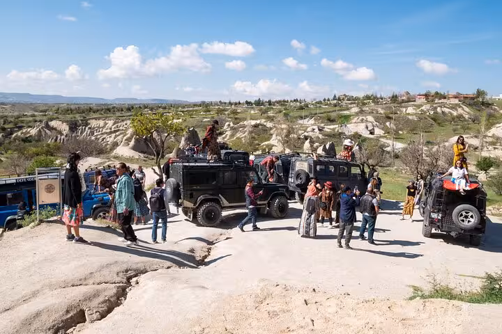 Cappadocia jeep safari stop with travelers on 2-day 1-night tour from Istanbul by plane with balloon ride