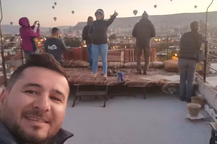 Cappadocia sunrise viewpoint with travelers and hot air balloons on a 3-day private Turkey tour