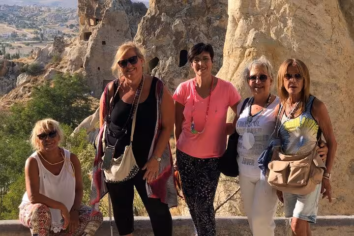 Spanish-guided 2-day Cappadocia tour travelers at Göreme rock caves viewpoint, including 2 internal flights