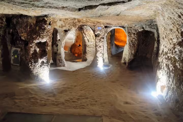 Underground city tunnels in Cappadocia with carved stone rooms visited on full-day tour from Istanbul by flight