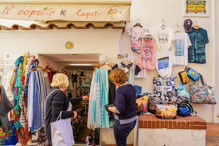 Visitors shopping at a colorful boutique in Capri, showcasing local fashion and souvenirs, a highlight of the island tour.
