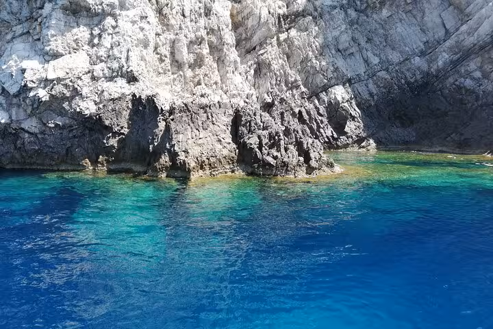 Crystal-clear turquoise waters lap against the rugged cliffs on the Capri and Anacapri tour.