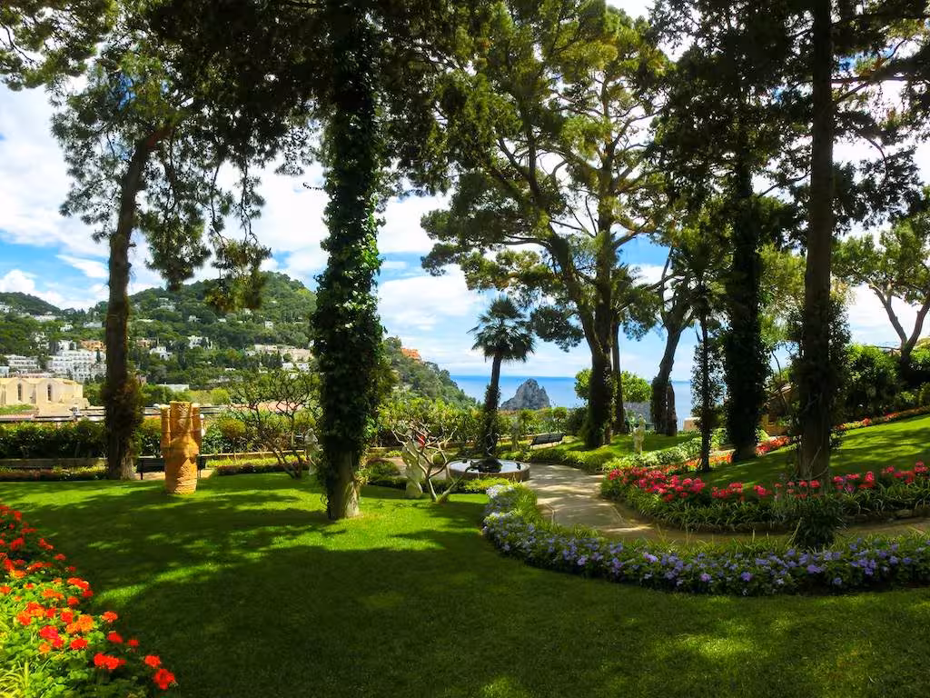 Scenic garden view in Capri with lush greenery and sea backdrop, highlighting the natural beauty of the Capri & Anacapri tour.