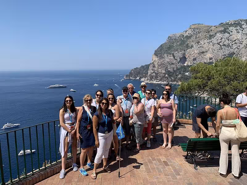 A group of tourists admire the stunning sea views from a Capri viewpoint on the Capri & Anacapri Select tour.