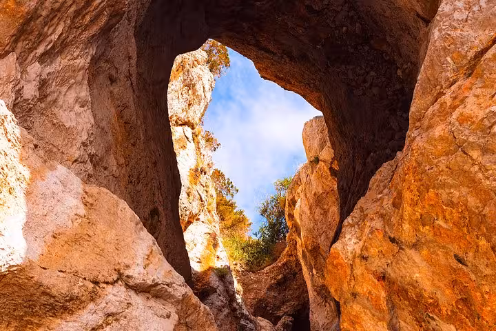 Stunning rock formations and a clear blue sky viewed from a natural cave on a Capri boat tour from Positano.
