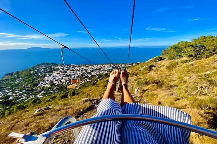 Scenic chairlift ride offers panoramic views over Capri's coastline, a thrilling experience on the private island tour.