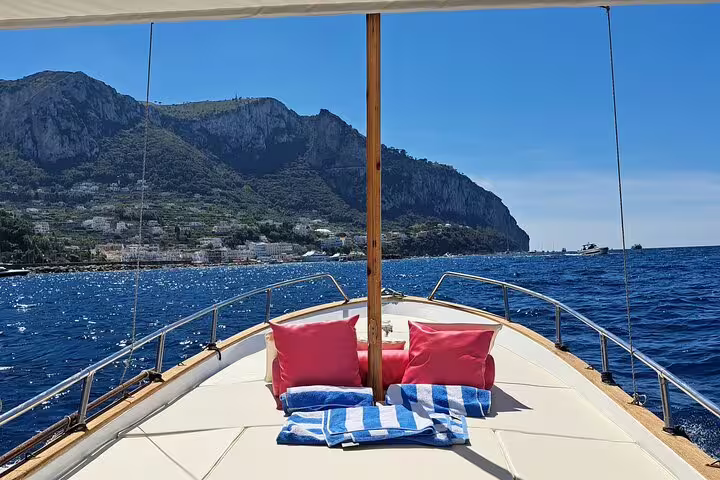Sun deck on private classic gozzo with Capri coastline views, perfect for a 3-hour boat tour