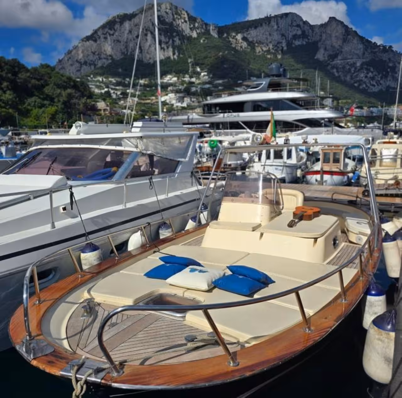 Classic gozzo boat in Capri marina with sunbed and cushions, ideal for Best of One Day Boat Tour cruise