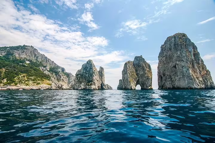 Faraglioni rock formations rising from blue waters off Capri Island, Italy