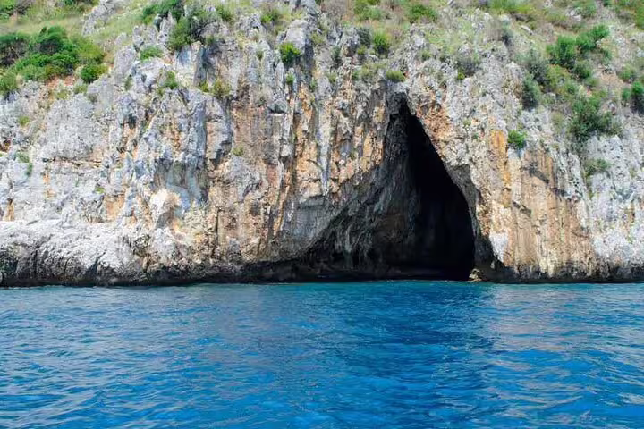 Sea cave on Capri coastline above turquoise water, seen on a 4-hour private classic boat tour