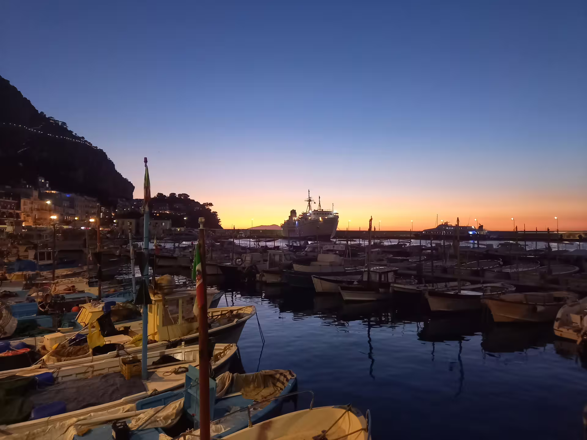 Blue hour harbor with fishing boats and sunset skyline, From Dusk Till Night immersive evening experience