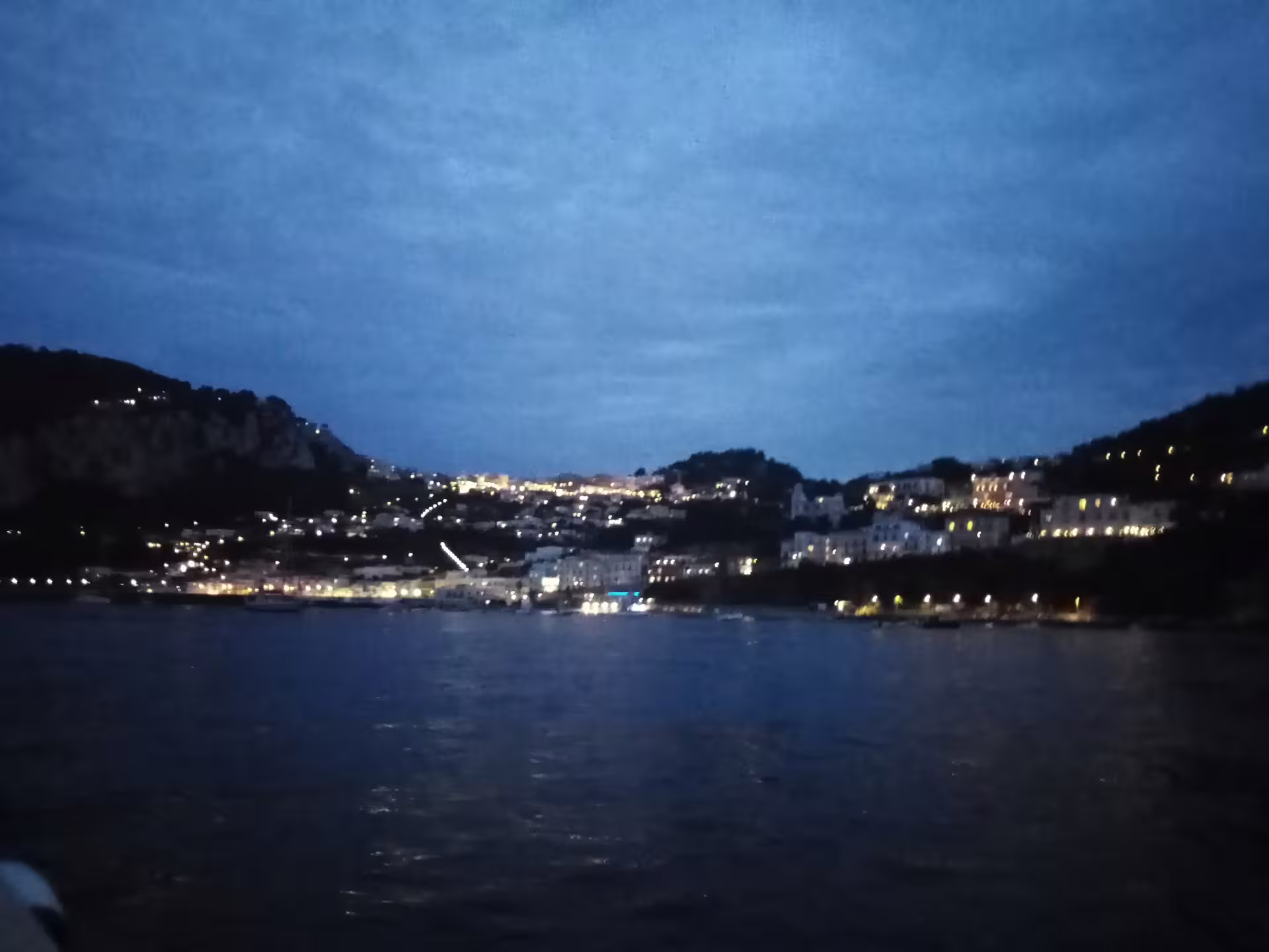 Dusk waterfront panorama with twinkling hillside lights, part of From Dusk Till Night immersive night tour