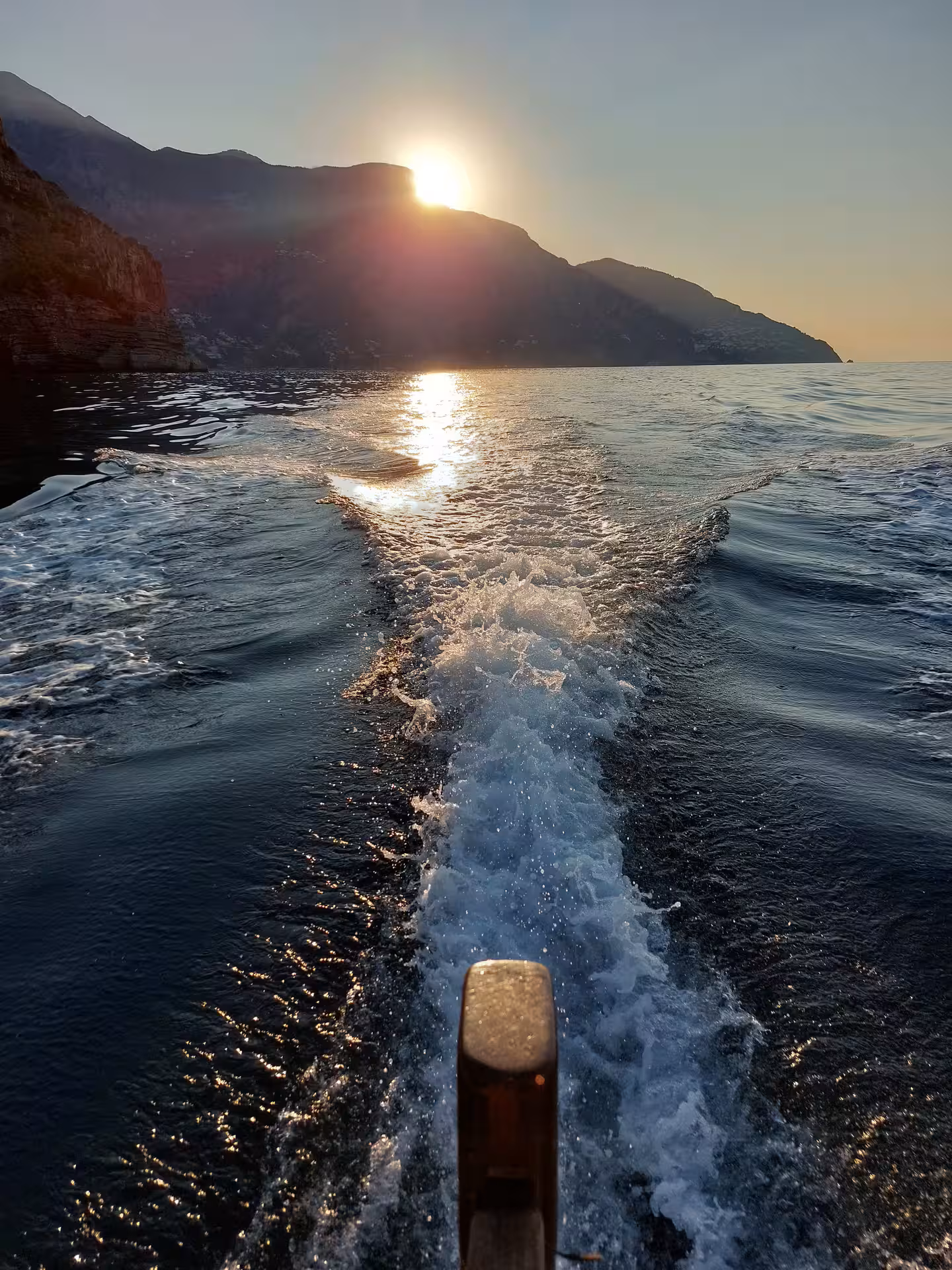 Speedboat wake at golden hour with coastal cliffs, From Dusk Till Night immersive experience on the water