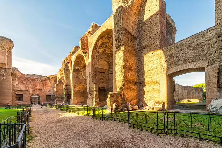 Sunlit ruins and towering arches of the Baths of Caracalla in Rome seen on an exclusive VIP private guided tour
